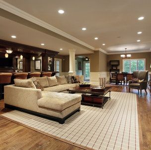 A living room filled with furniture and a rug