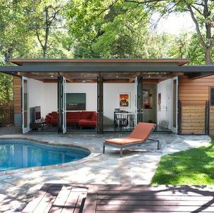 A small house with a swimming pool in the backyard.