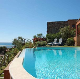 A large swimming pool with a view of the ocean