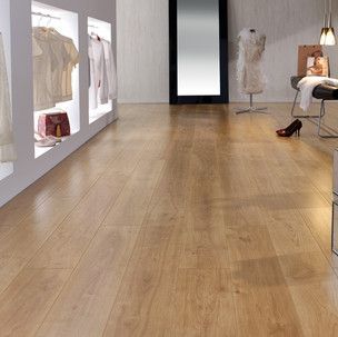 A room with a wooden floor and a mirror.