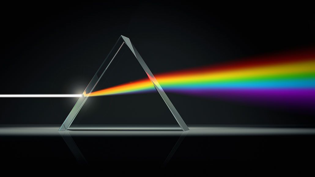 A rainbow is being reflected from a glass prism.