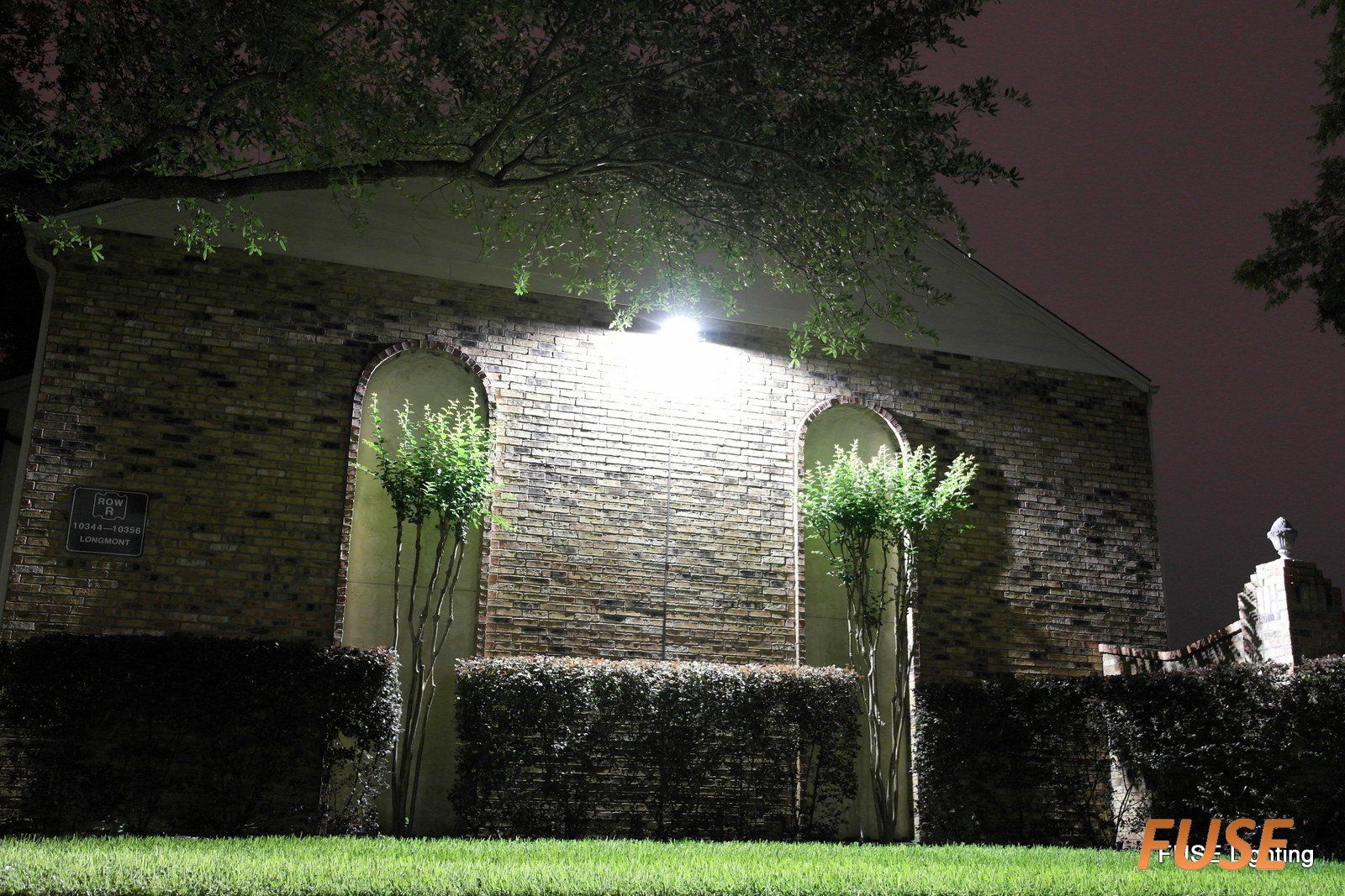 A brick building with a light on the side of it