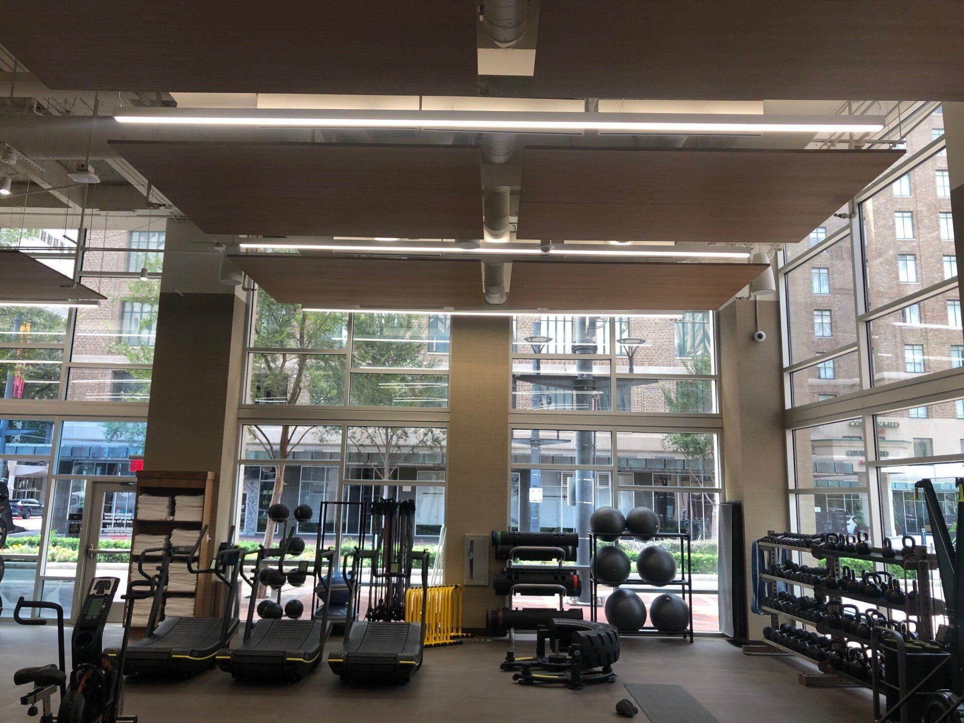 A large gym with a lot of equipment and a lot of windows.