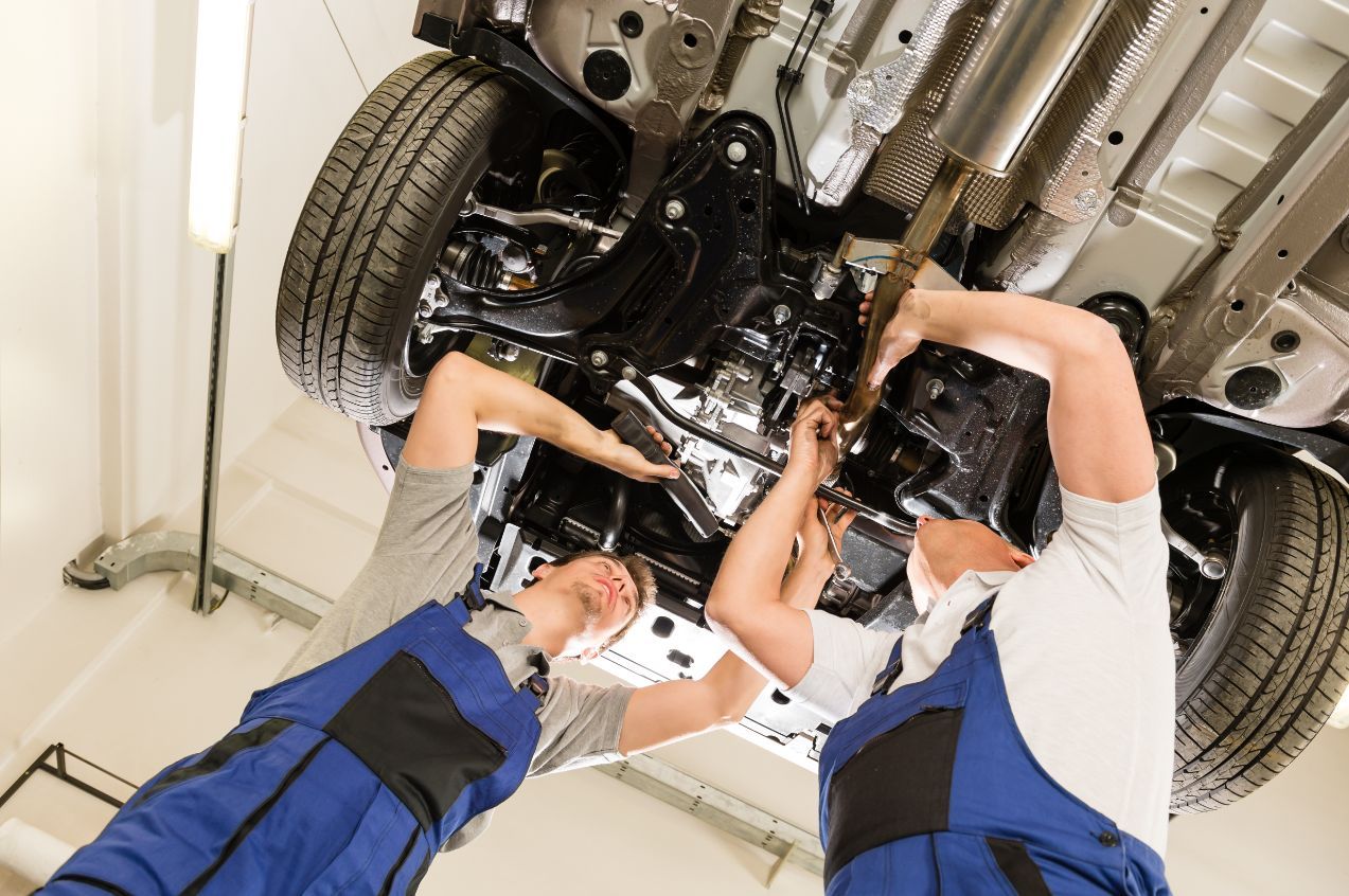 Mechanics Fixing A Car — Rasmussen Mechanical & Tyres in Garbutt, QLD