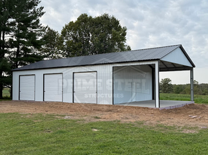 A blue and white metal building with a carport attached to it.
