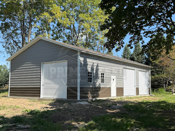 A large metal building with a porch on the side of it.