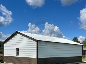 A blue carport is sitting in the middle of a grassy field.