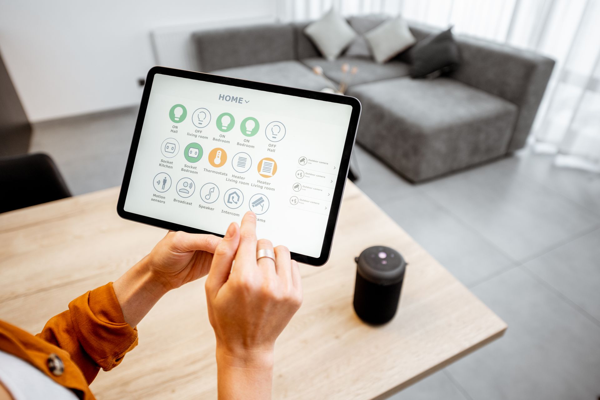 woman adjusting temperatures in home using consumer electronic device