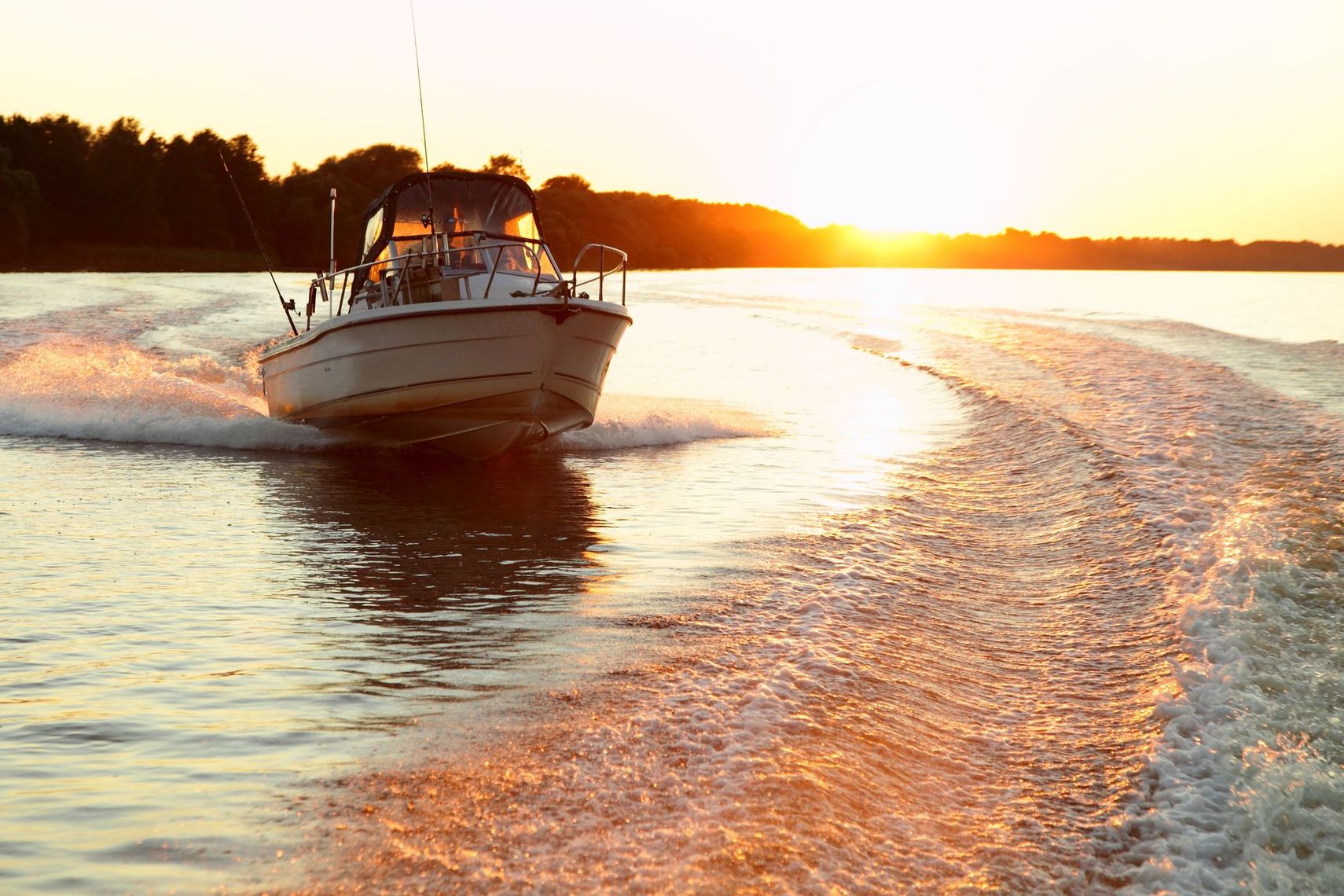 sport fishing boat returning at sunset