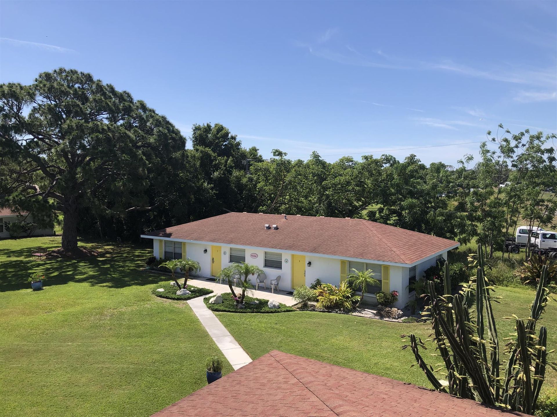 An aerial view of a house with a red roof