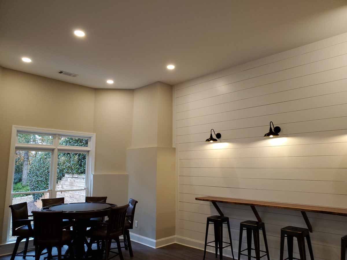 A dining room with a table and chairs and a window.