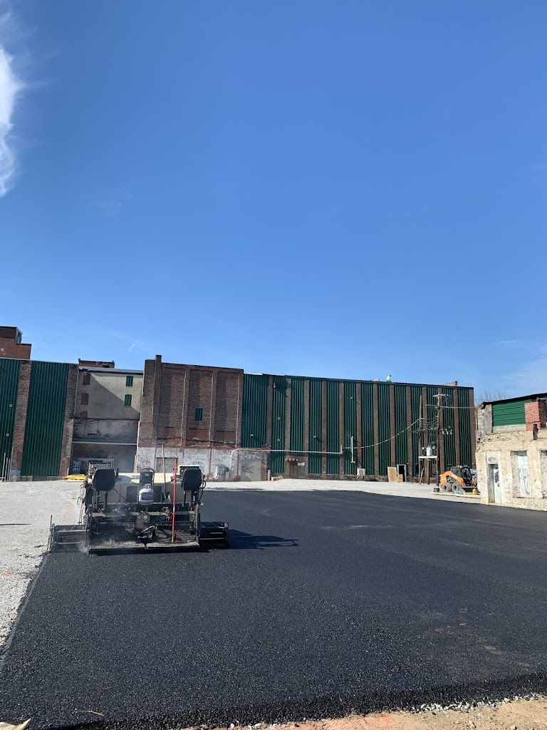 A Machine is Laying Asphalt in a Parking Lot in Front of a Building — Kutztown, PA — B Young Paving