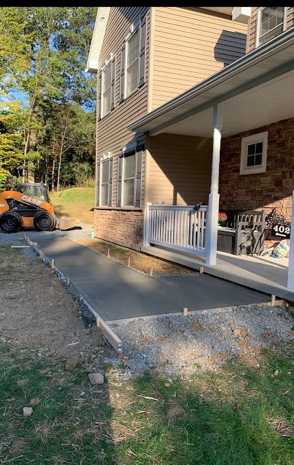 A Concrete Walkway is being Built in Front of a House — Kutztown, PA — B Young Paving