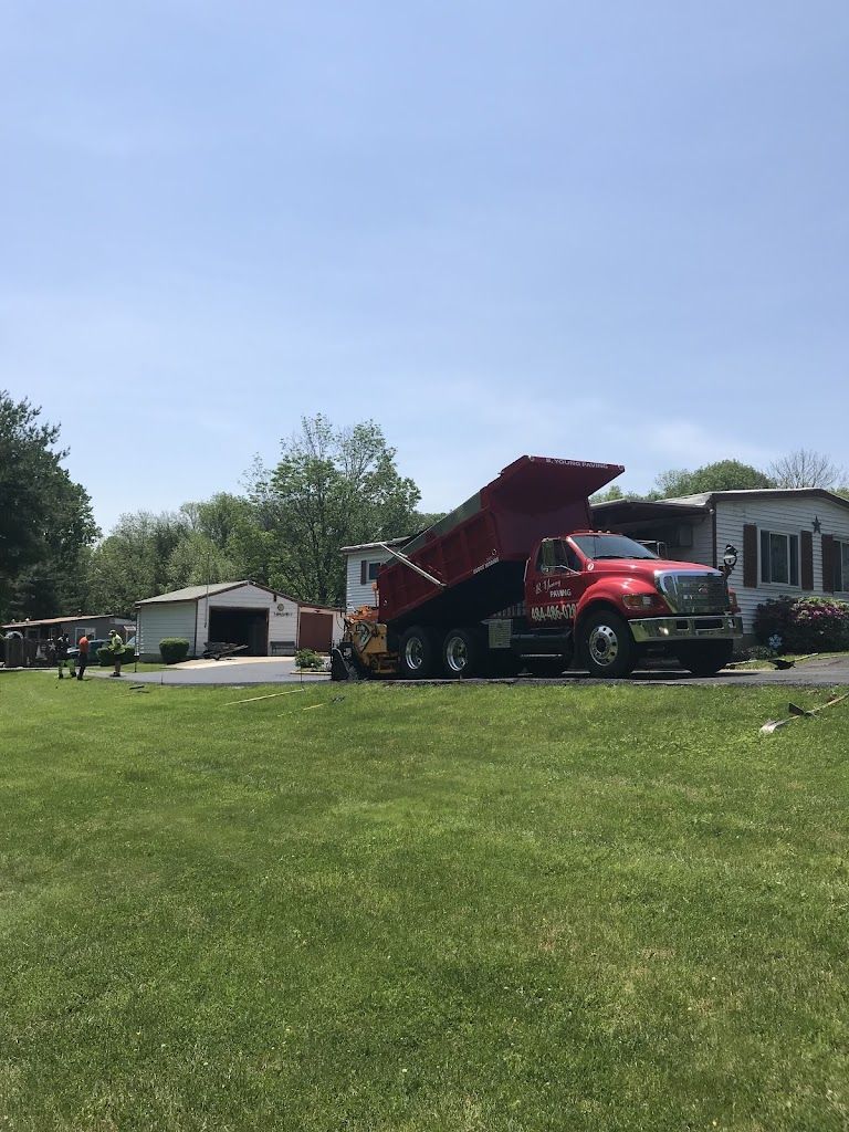 A Red Dump Truck is Parked in a Grassy Field — Kutztown, PA — B Young Paving