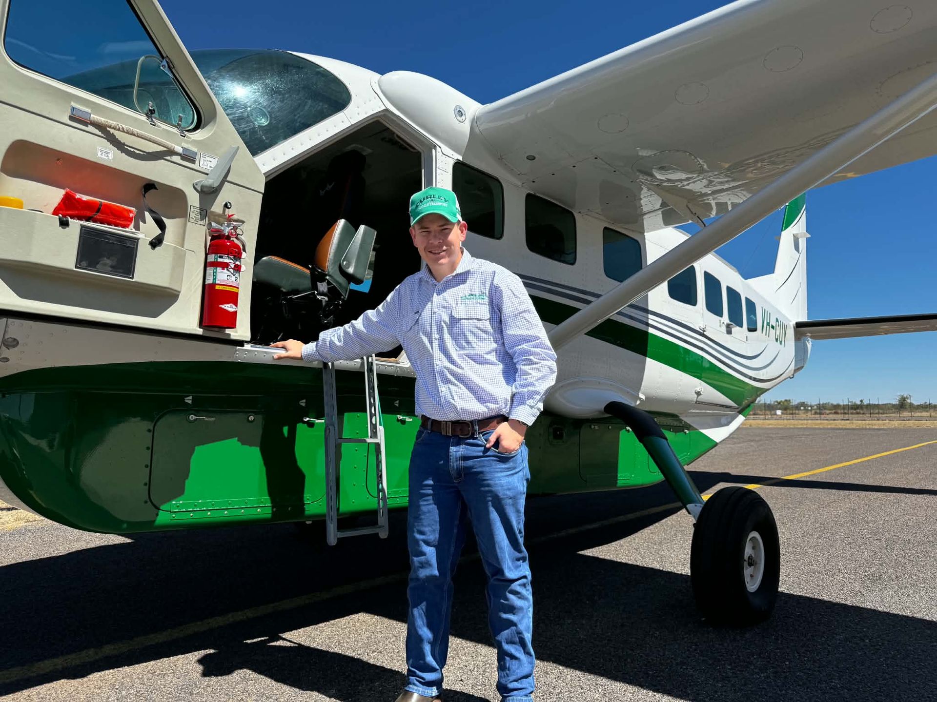 Todd Fogarty, 2026 Roger Connellan Award winner, beside a light aircraft