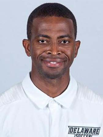 Faisal wearing a white polo shirt with