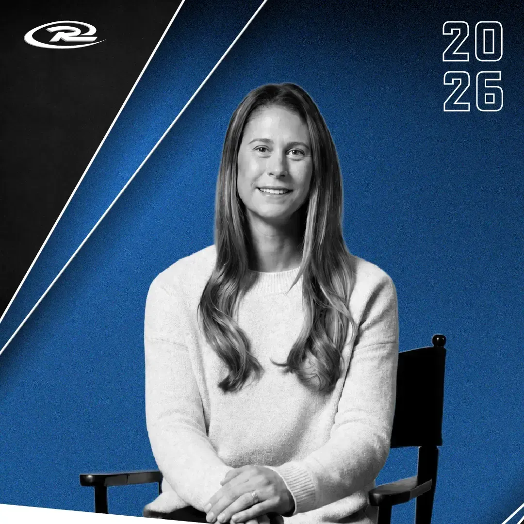 Black-and-white portrait of a seated person on a blue background with “2026” in the corner