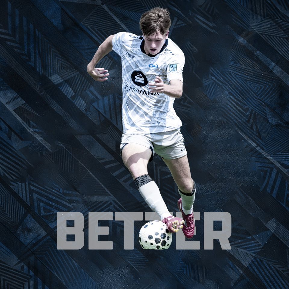 A soccer player in a white jersey with
