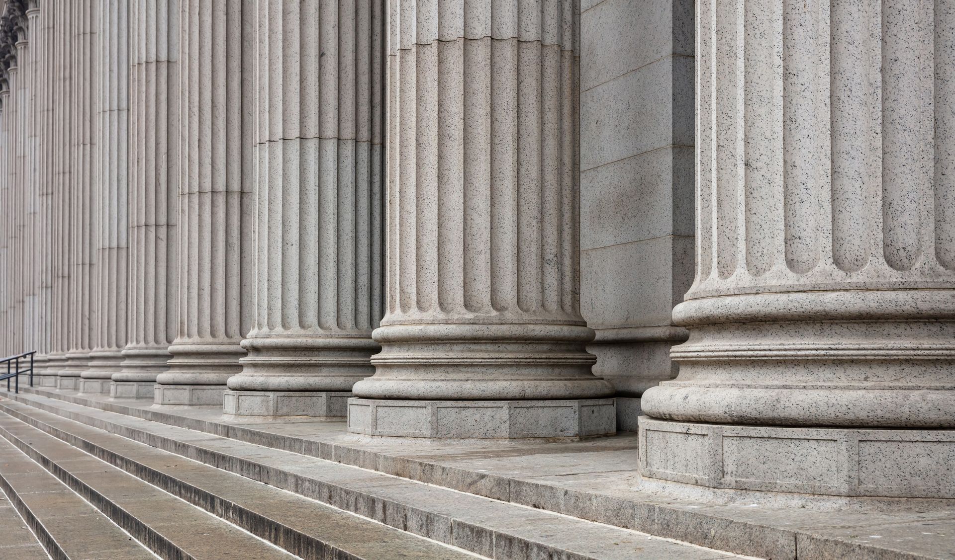 Row of classical stone columns with steps, likely a government building.