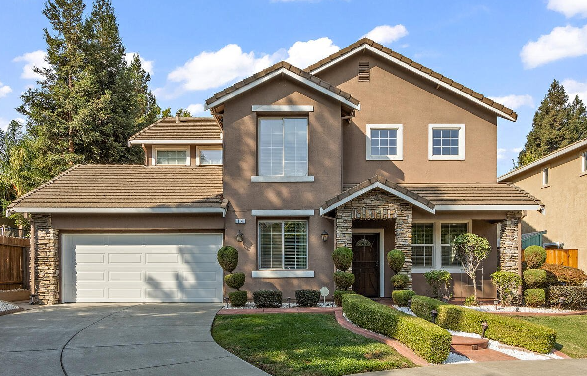 A large brown house with a white garage door | Buy a House with the best Realtor in Greenhaven-Pocket, CA | Renee Catricala