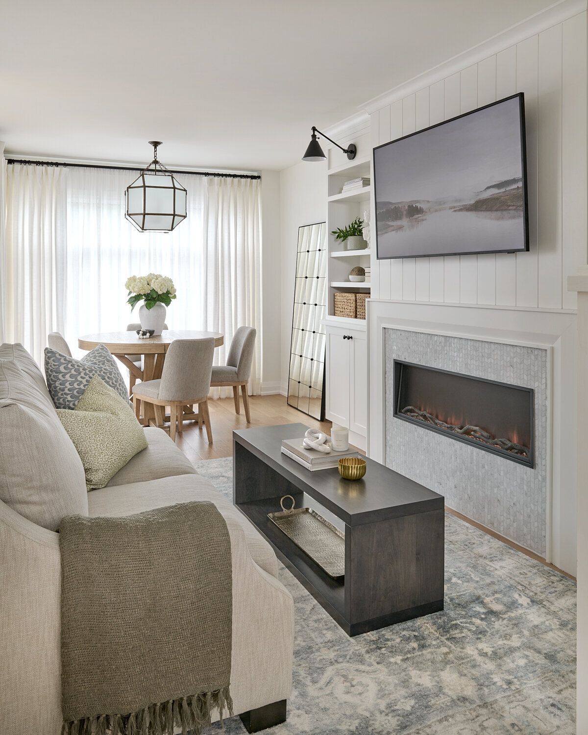 A living room with a fireplace, couch, table, and television | Buy a Home in Greenhaven-Pocket, Sacramento, CA