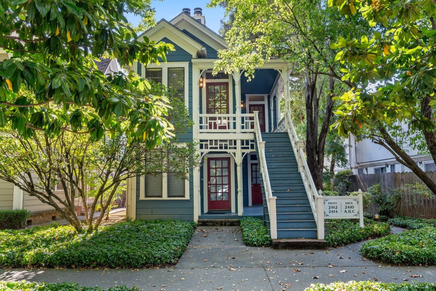 A blue and white house with stairs leading up to the second floor | Buy a Home in Greenhaven-Pocket, Sacramento, CA