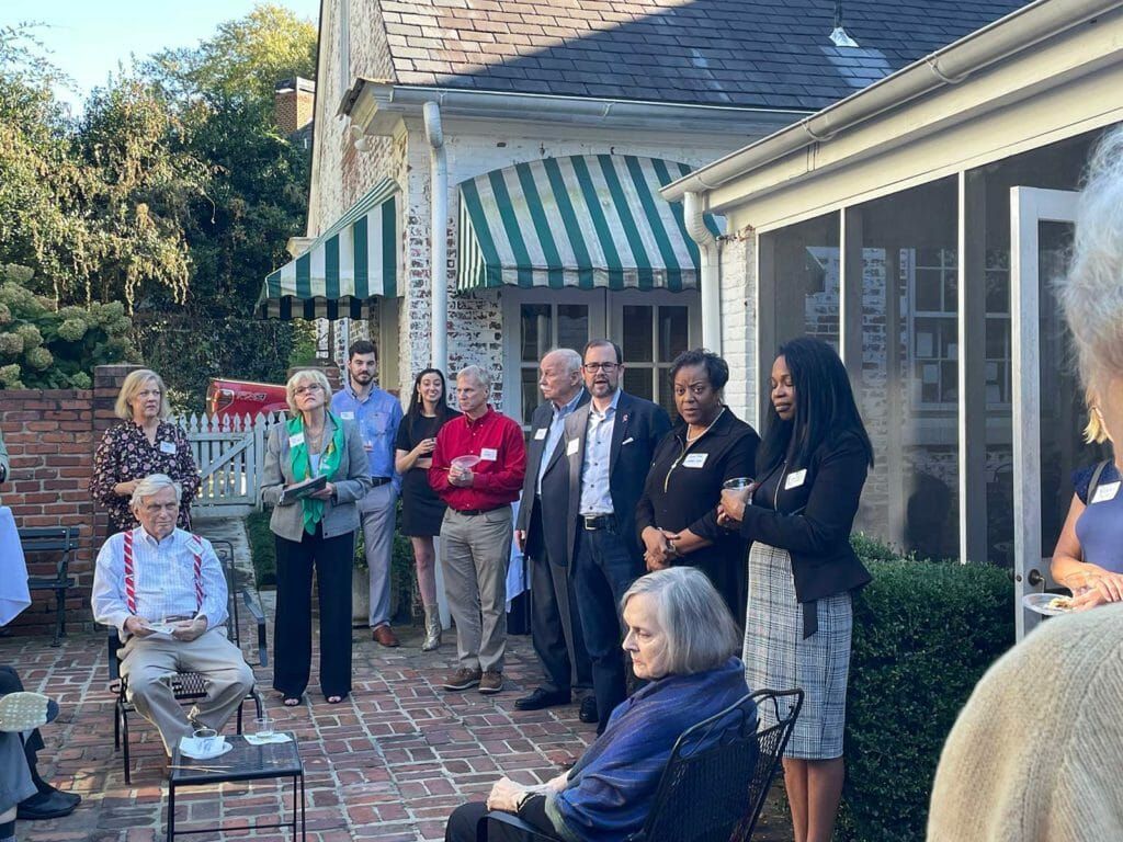 A Group Of People Are Standing Outside Of A House — Atlanta, GA — Lutheran Towers