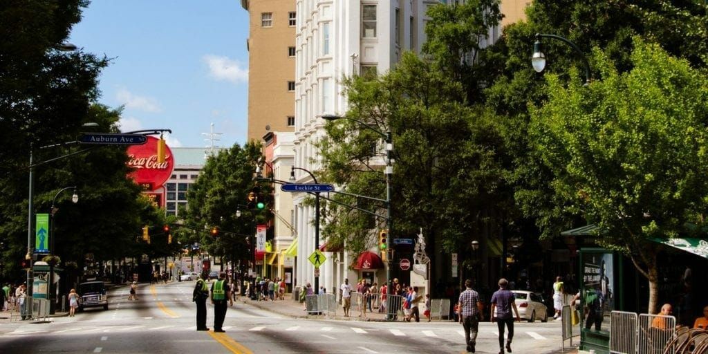 A Couple Of People Are Walking Down A City Street — Atlanta, GA — Lutheran Towers