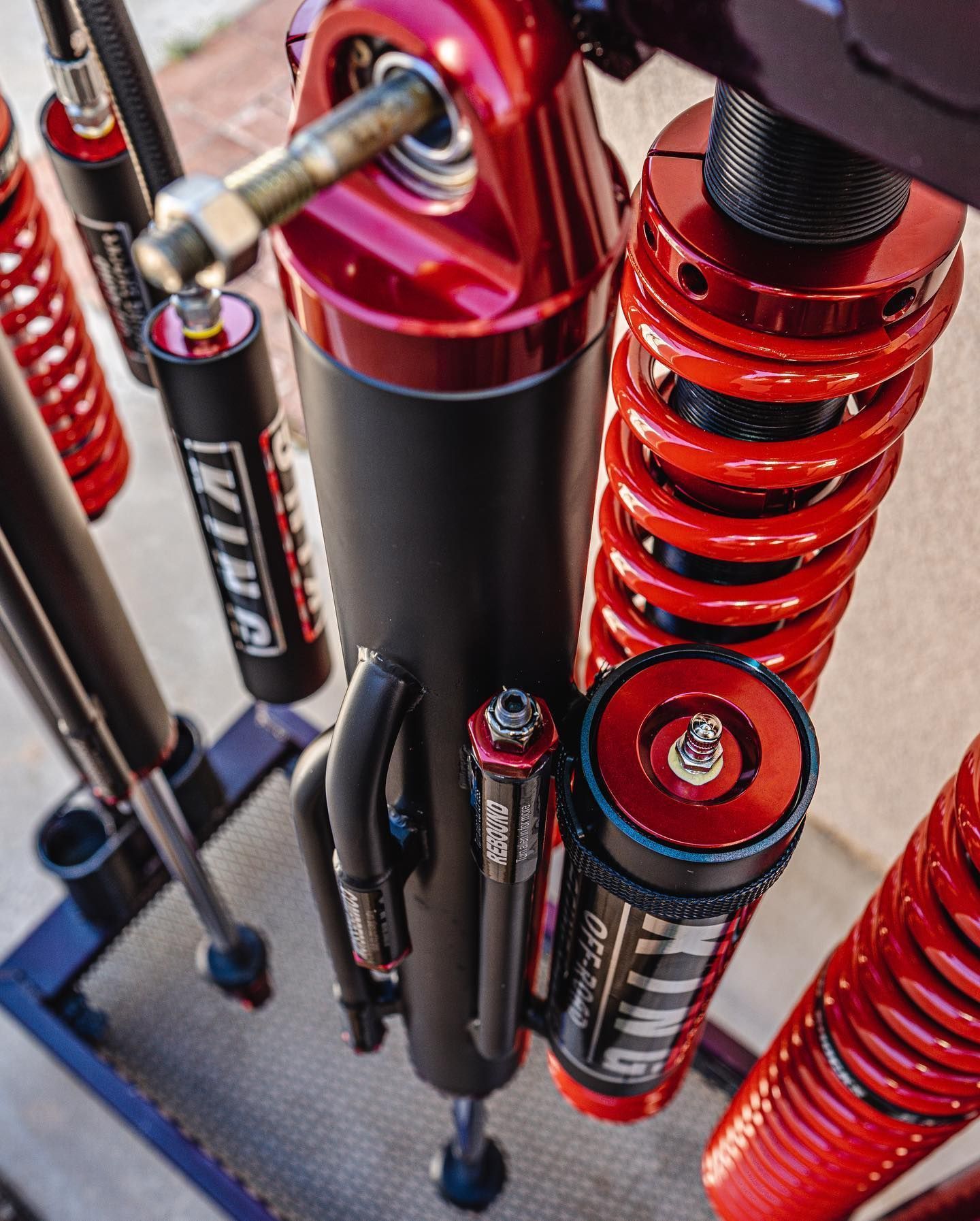 Close-up of a high-performance red and black King off-road shock absorber and coil-over suspension system.