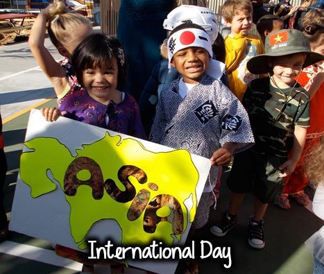 A group of children holding a sign that says international day