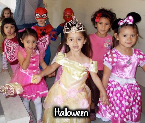 A group of little girls dressed in halloween costumes