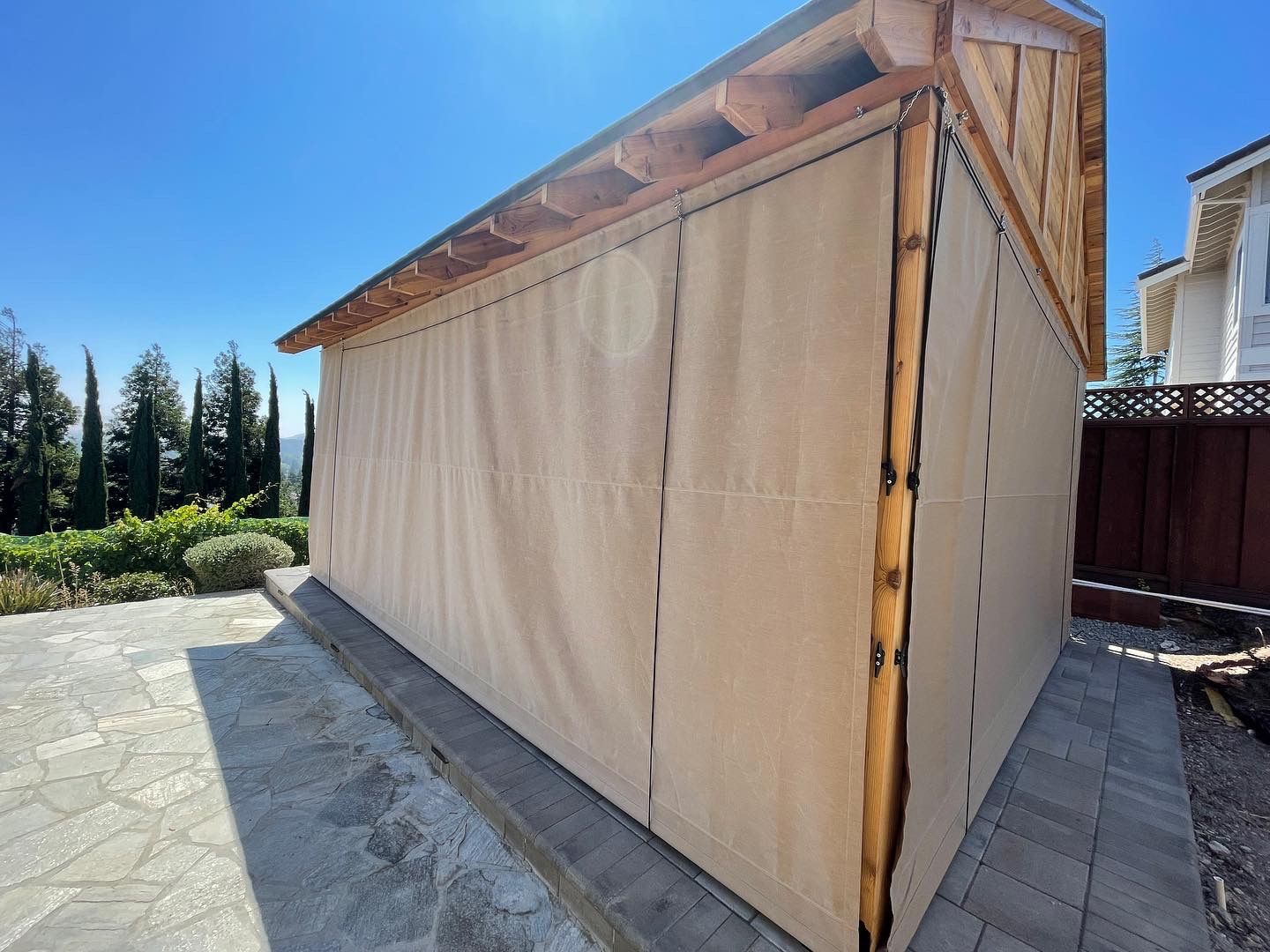 A shed with a curtain on the side of it.