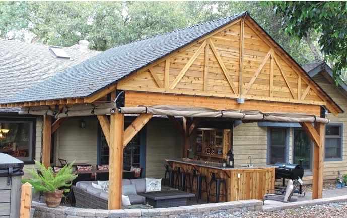A house with a wooden porch with a bar underneath it