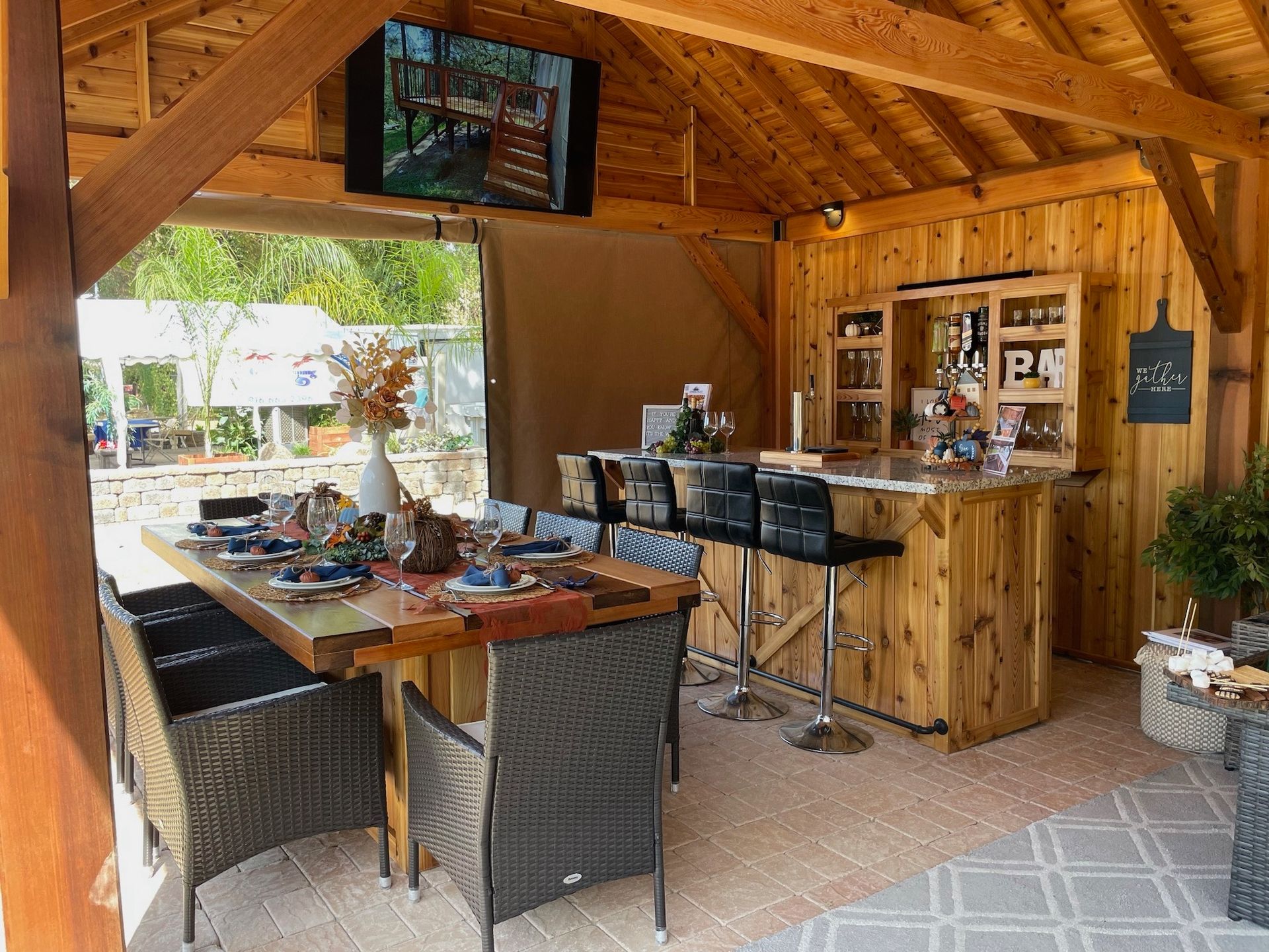 A dining room with a table and chairs and a bar.