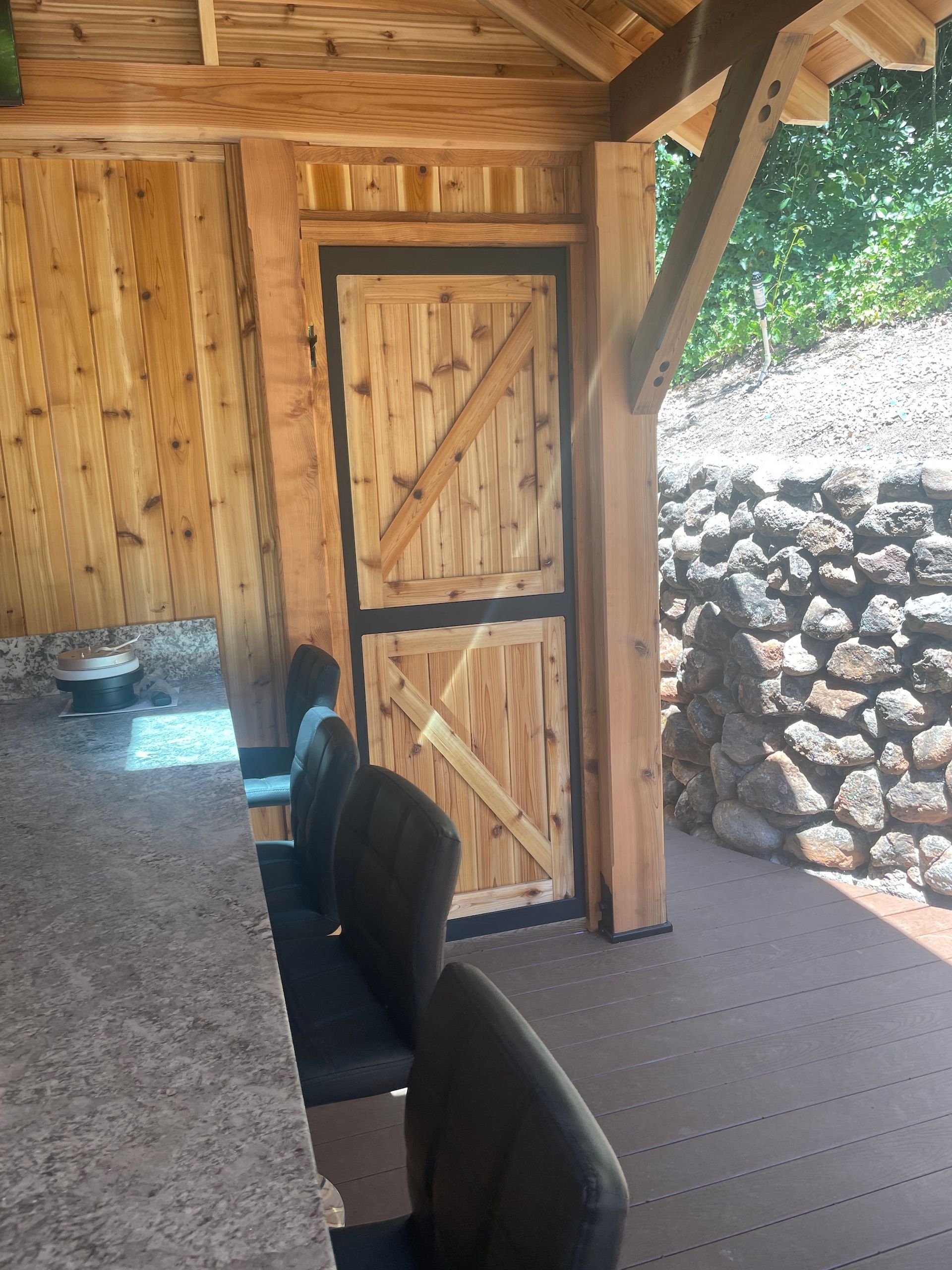 A wooden shed with a sliding barn door