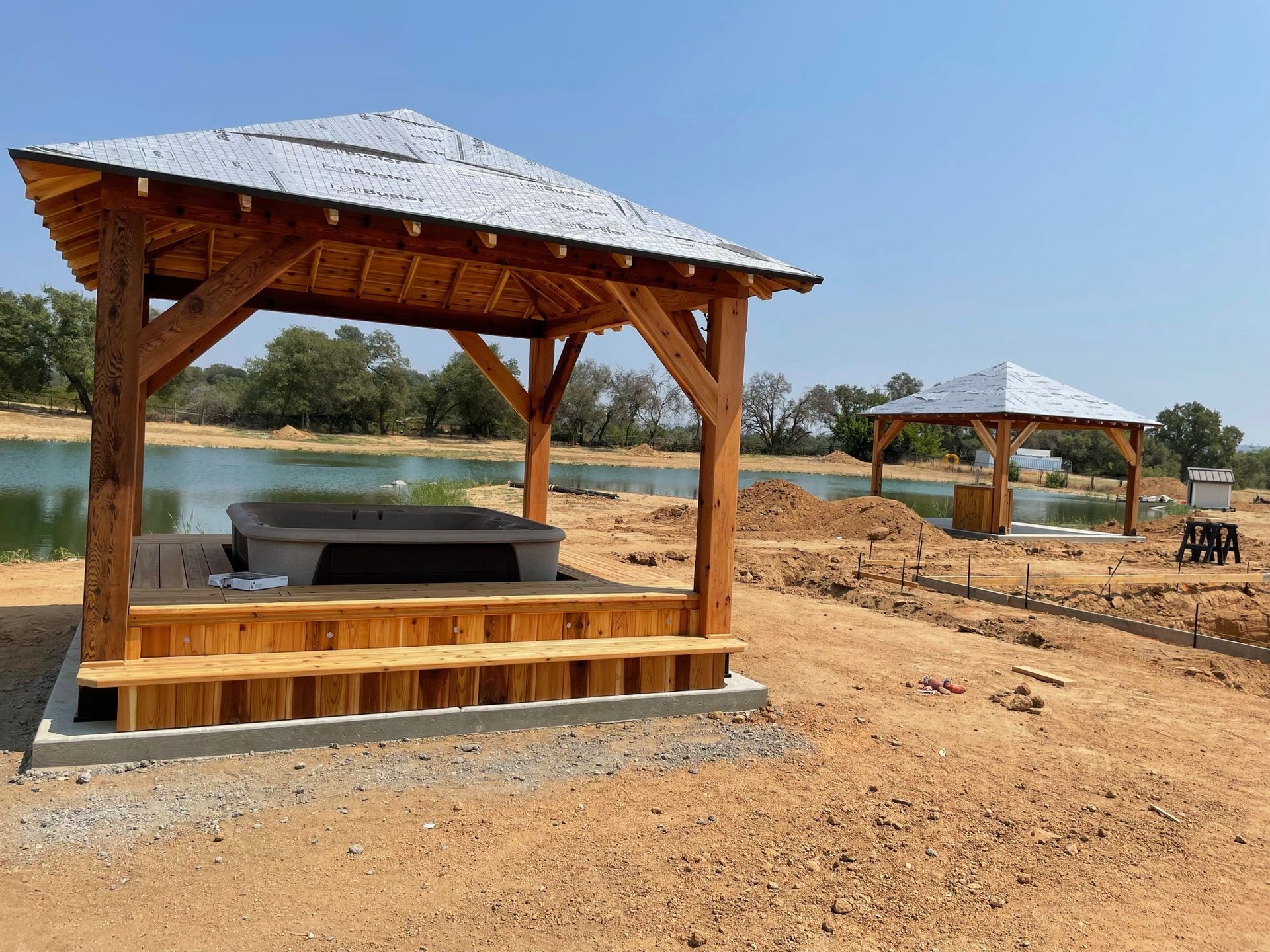There is a gazebo with a hot tub underneath it.