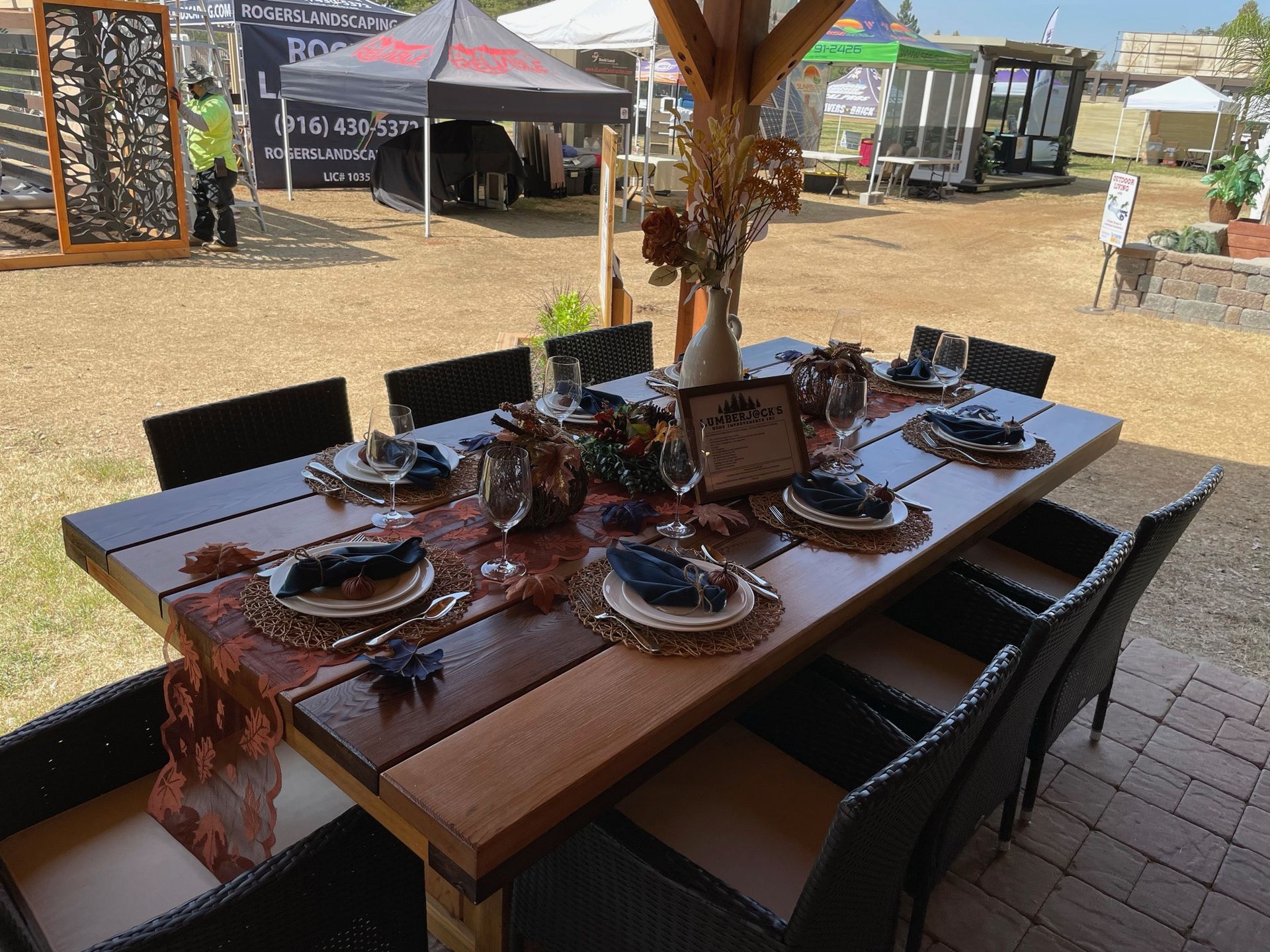 A large wooden table with plates and napkins on it