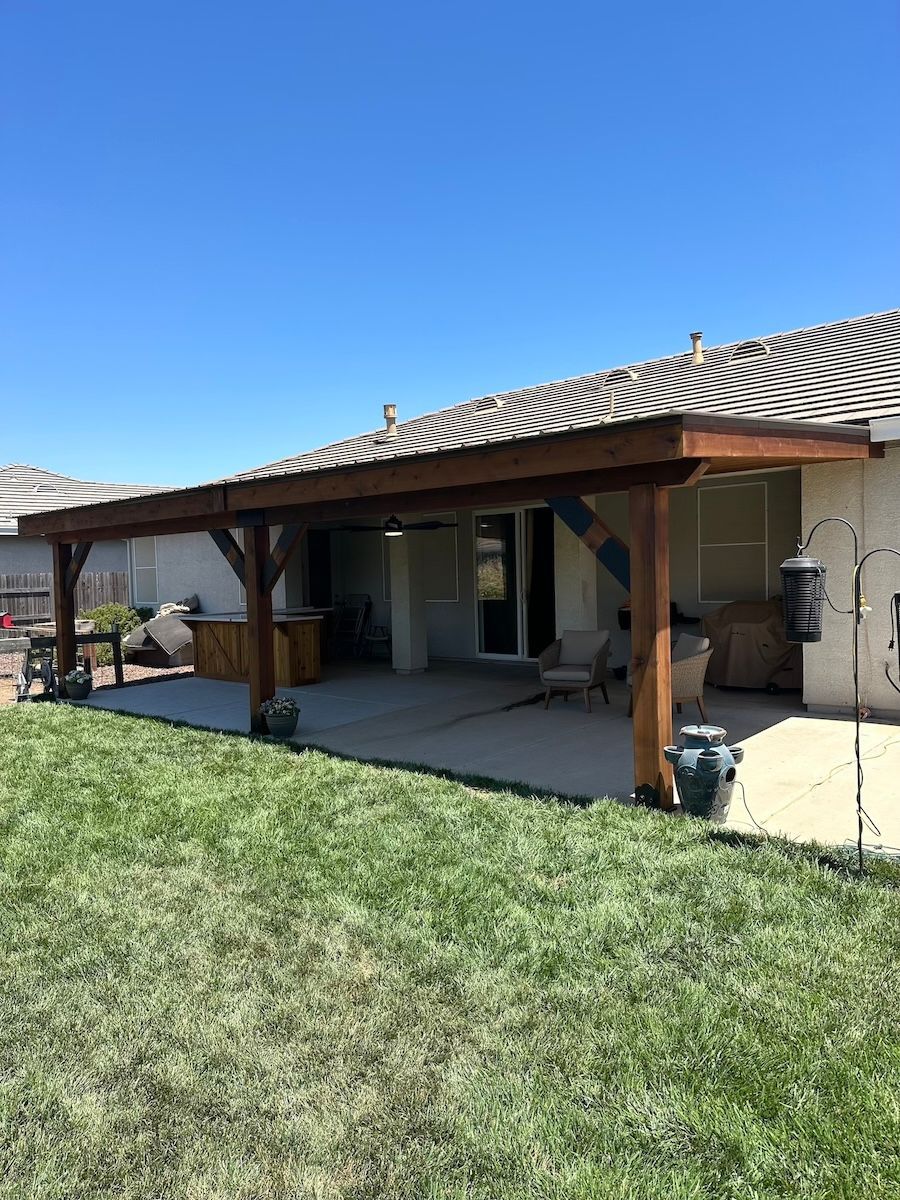 A house with a covered patio in the backyard.