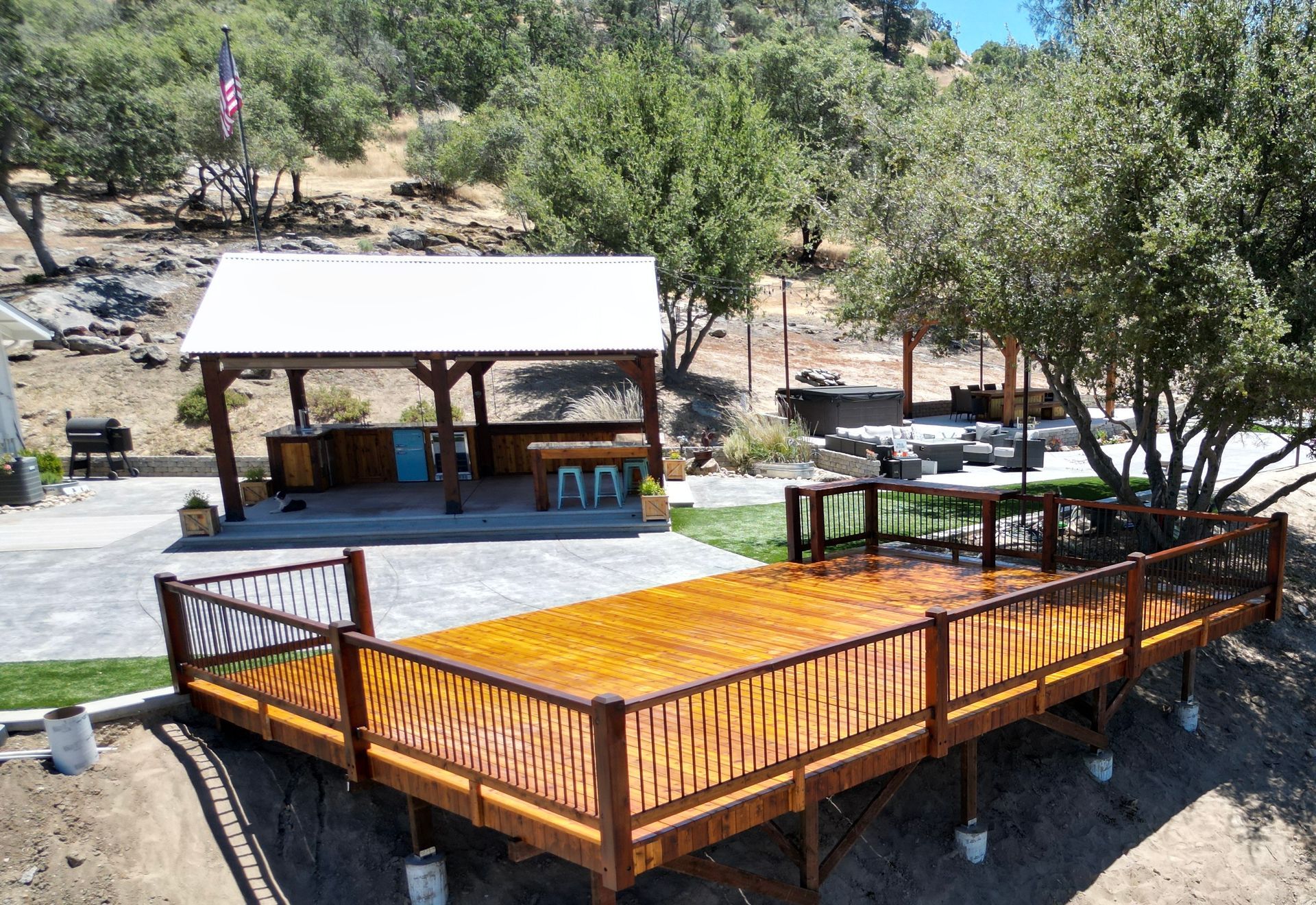 An aerial view of a wooden deck with a gazebo in the background.