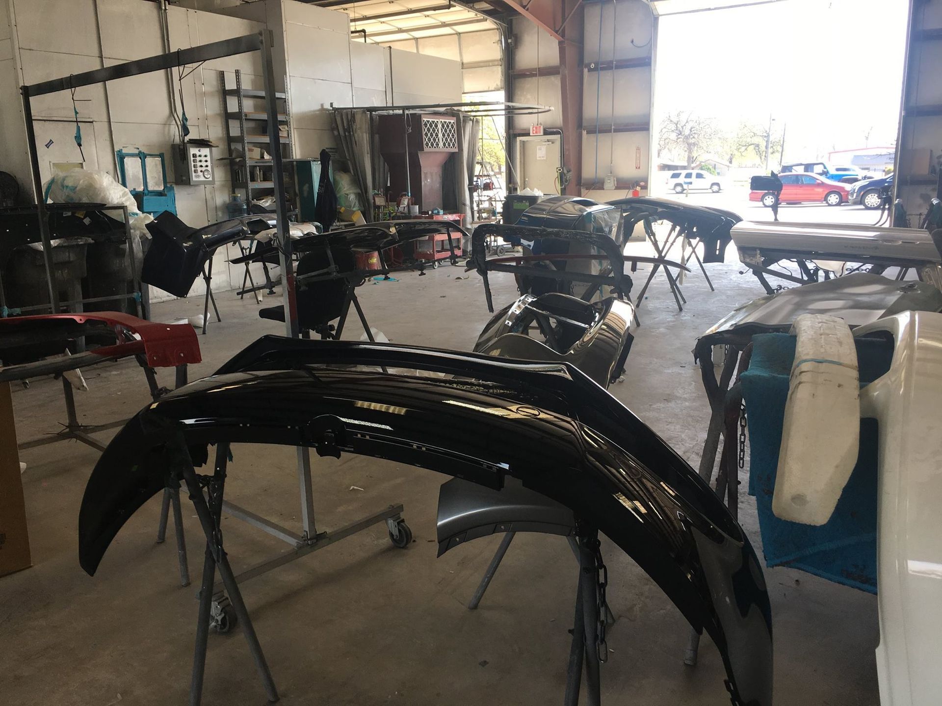 A garage with a lot of black fenders on display