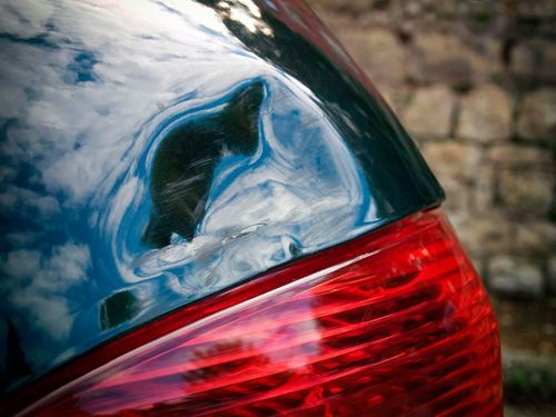 A close up of the back of a car with a damaged tail light.