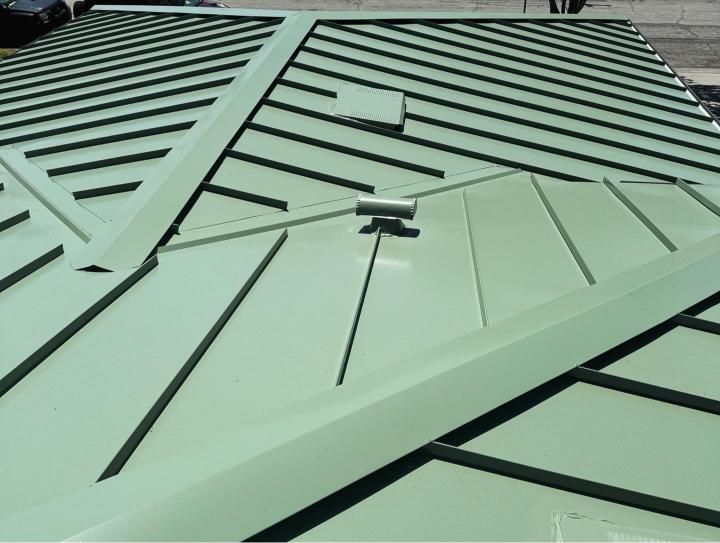 A close up of a metal roof with black stripes.