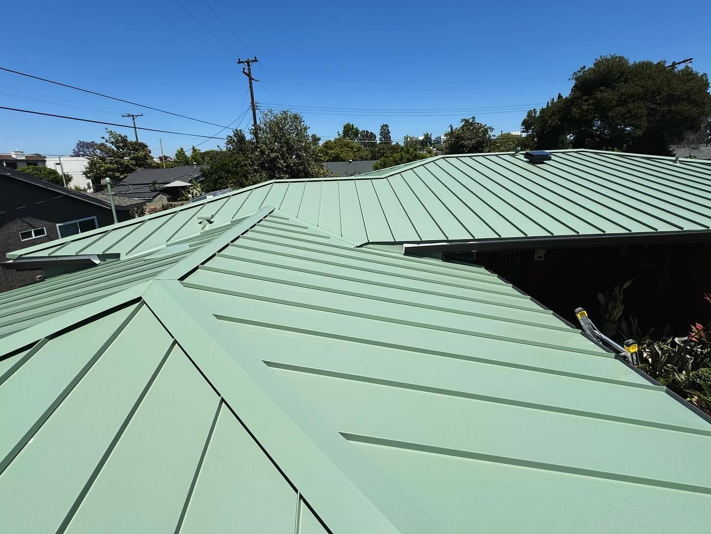 A green roof with a blue sky in the background