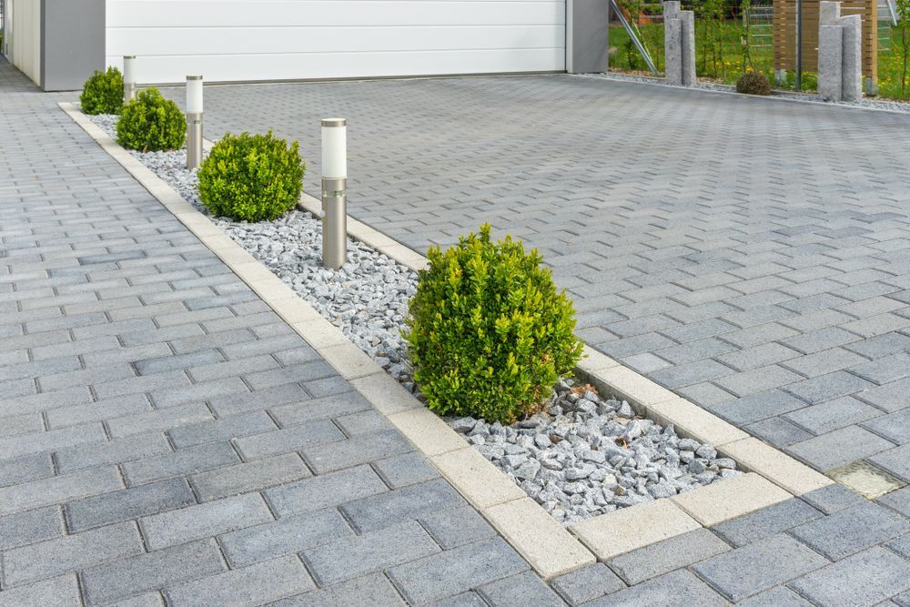 A Concrete Driveway With A Trash Can On The Side Of It — B & C Donnachie Concrete Contractors in Kuranda, QLD