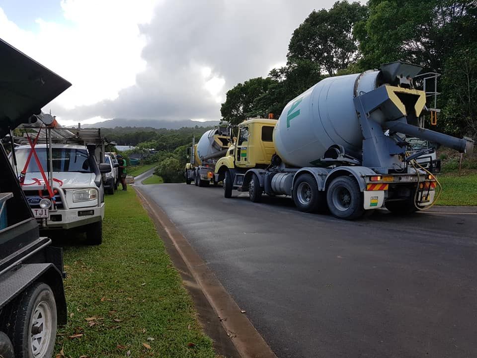 A Concrete Mixer Truck Is Parked On The Side Of The Road — B & C Donnachie Concrete Contractors in Mareeba, QLD