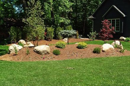 A House With A Lush Green Lawn And Rocks — Menasha, WI — Artscapes COC