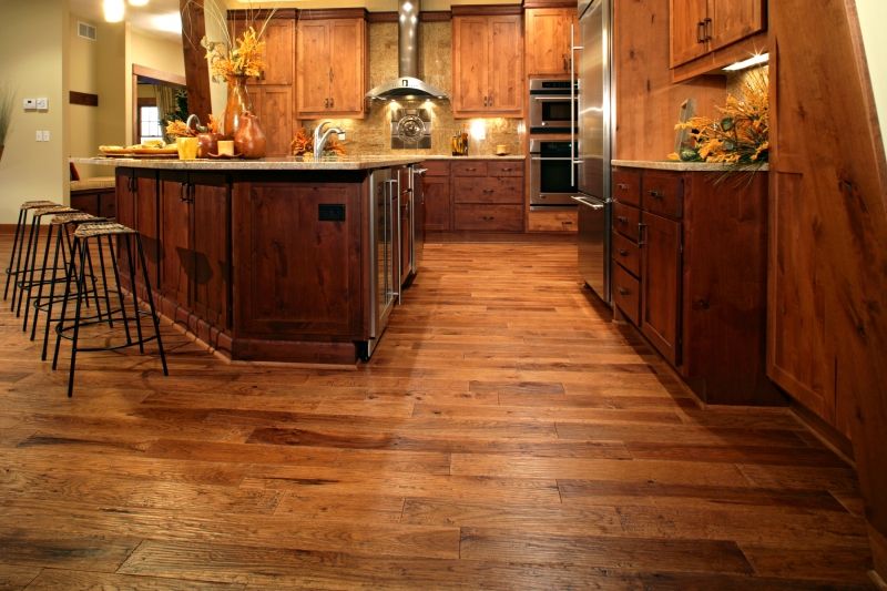 A kitchen with hardwood floors and stainless steel appliances