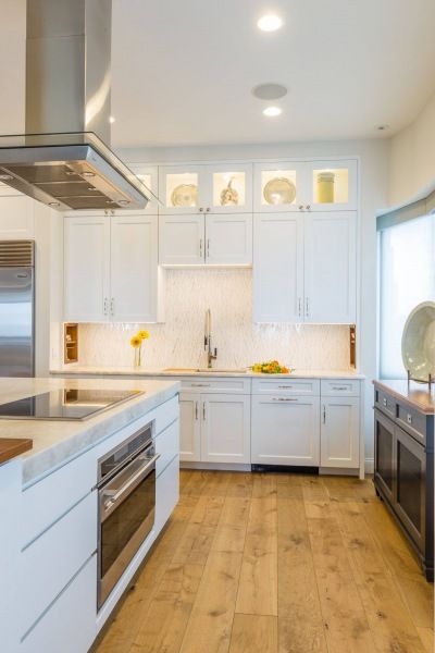 A kitchen with white cabinets and stainless steel appliances