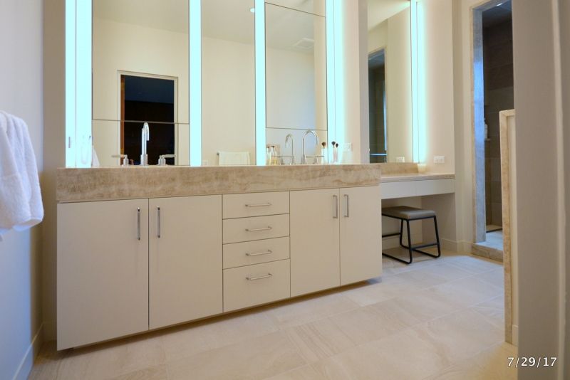 A bathroom with two sinks and two mirrors.