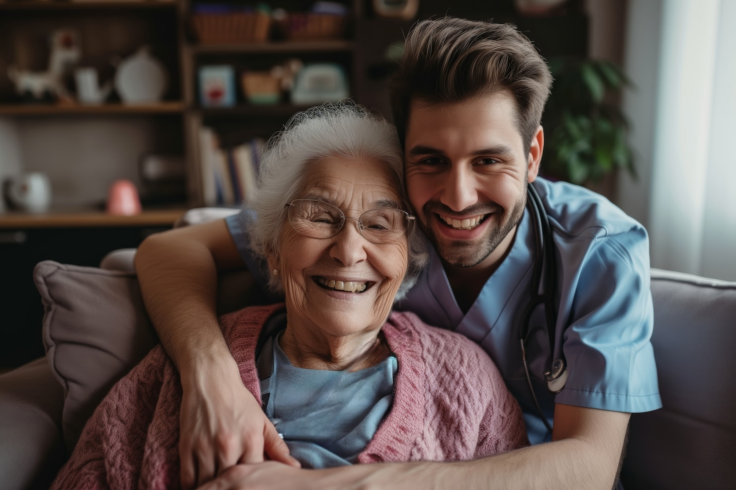 A man is hugging an elderly woman on a couch.